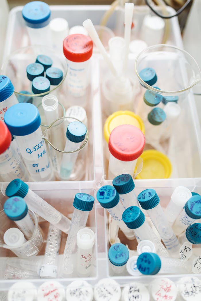 A variety of labeled laboratory test tubes with caps in a research setting.